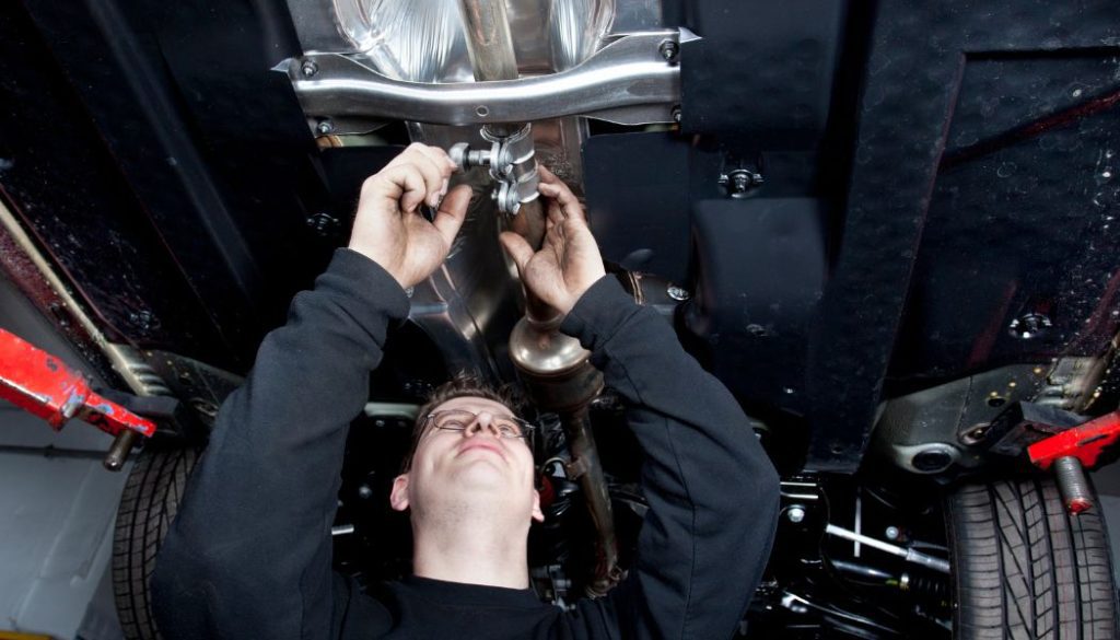 a man is working on a car under the hood