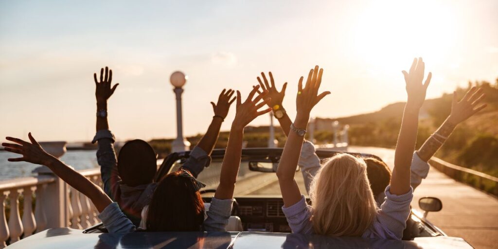 A group of people driving happily.