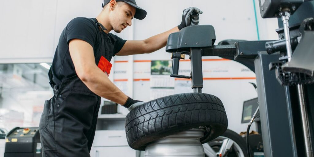 A technician replacing a flat tire at Anthon's Auto Service in chehalis