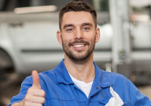 a man in a blue uniform is giving the thumbs up