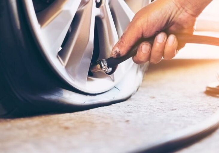 a person is using a hose to change the tire on a car