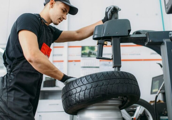 A technician replacing a flat tire at Anthon's Auto Service in chehalis