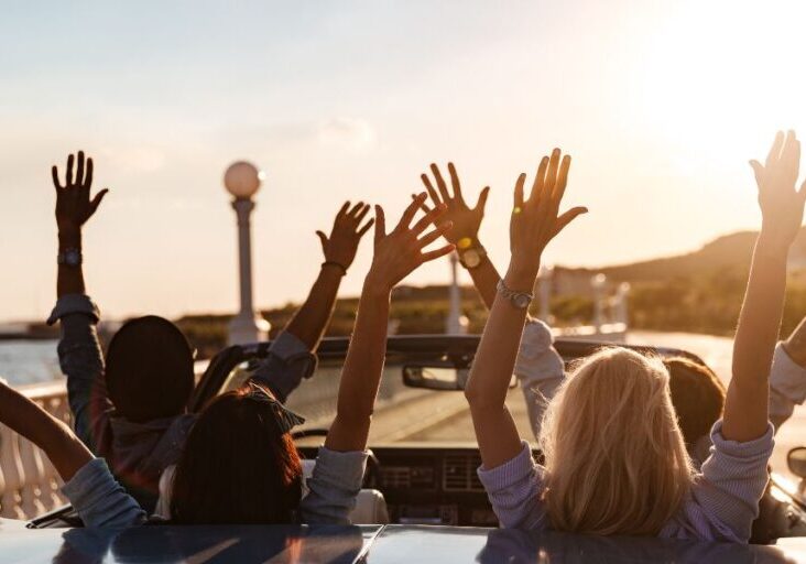 A group of people driving happily.